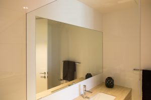 Polished edge mirror over vanity
